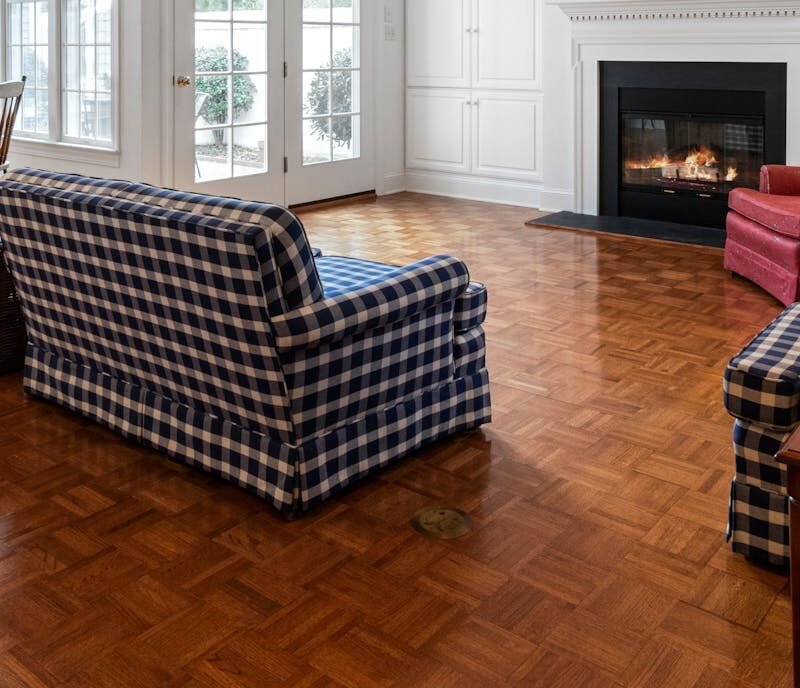 A bright, spacious living room with elegant furniture and a cozy fireplace, ideal for modern home design inspiration.